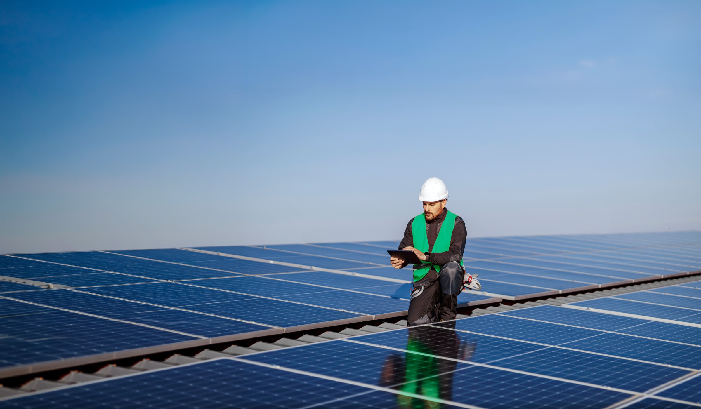 An engineer inspecting rooftop solar panels at DP World London Gateway