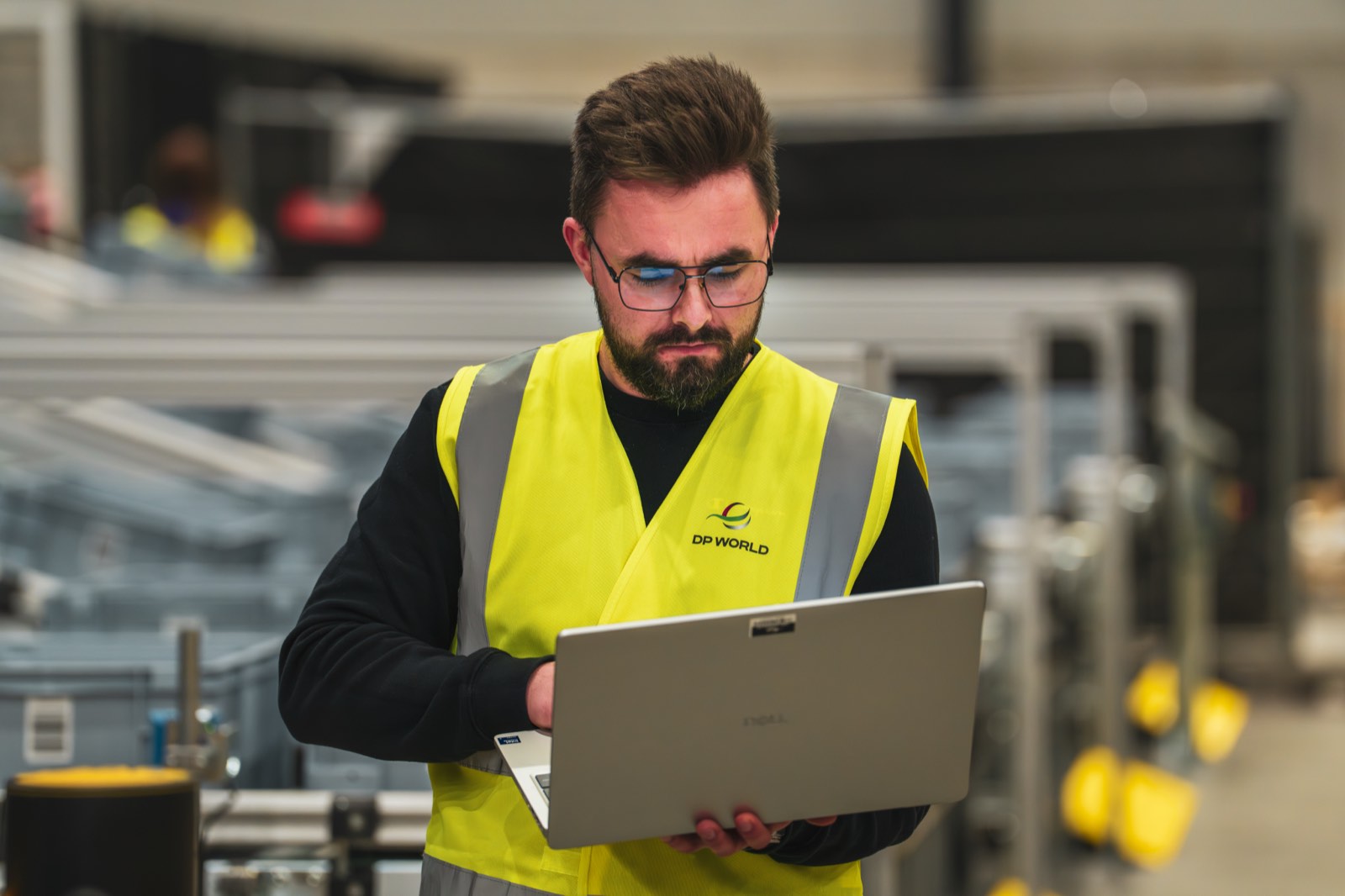 A DP World engineer reviewing plant data on a laptop